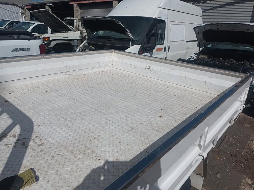 The Back of a White Truck with the Hood Open — South West 4WD Wreckers In Brisbane, QLD