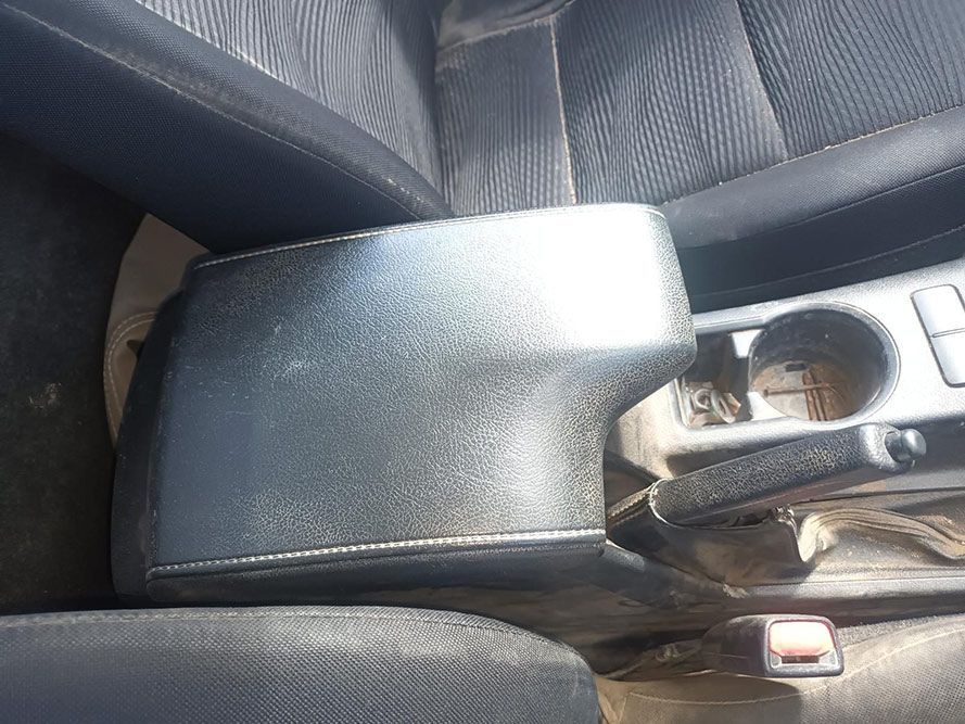 A Black Arm Rest in a Car with a Cup Holder — South West 4WD Wreckers In Brisbane, QLD