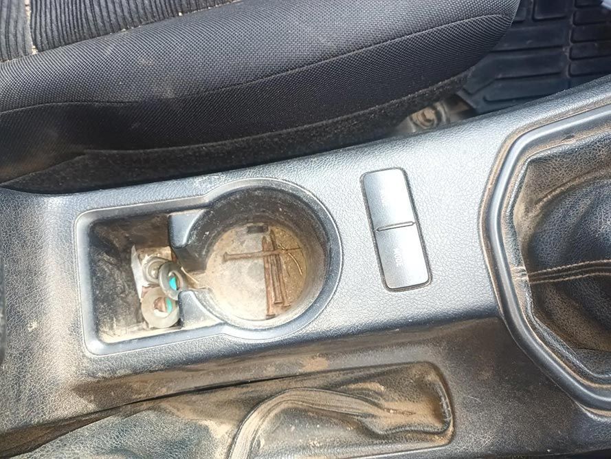 A Close Up of a Dirty Car Console with a Cup Holder — South West 4WD Wreckers In Brisbane, QLD