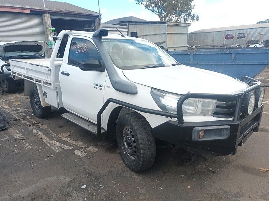 A White Truck with a Snorkel is Parked in a Parking Lot — South West 4WD Wreckers In Brisbane, QLD