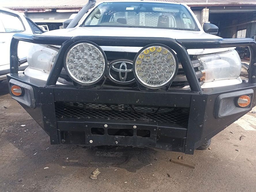 A White Toyota Hilux with a Black Bumper is Parked in a Parking Lot — South West 4WD Wreckers In Brisbane, QLD