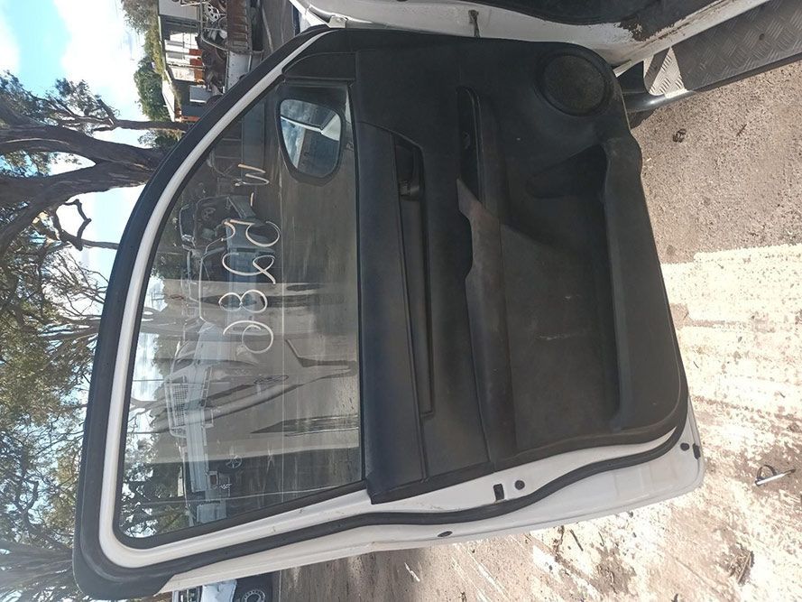 A White Car with the Door Open is Parked on the Side of the Road — South West 4WD Wreckers In Brisbane, QLD
