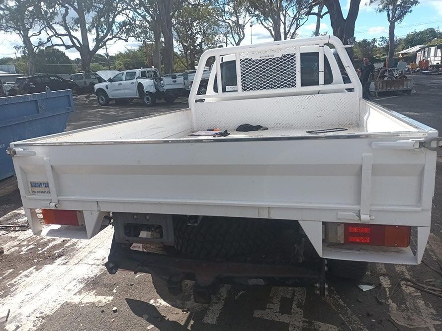 A White Truck is Parked in a Parking Lot — South West 4WD Wreckers In Brisbane, QLD