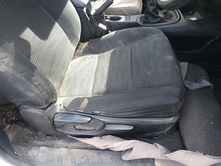 A Dirty Car Seat is Sitting in the Back Seat of a Car — South West 4WD Wreckers In Brisbane, QLD