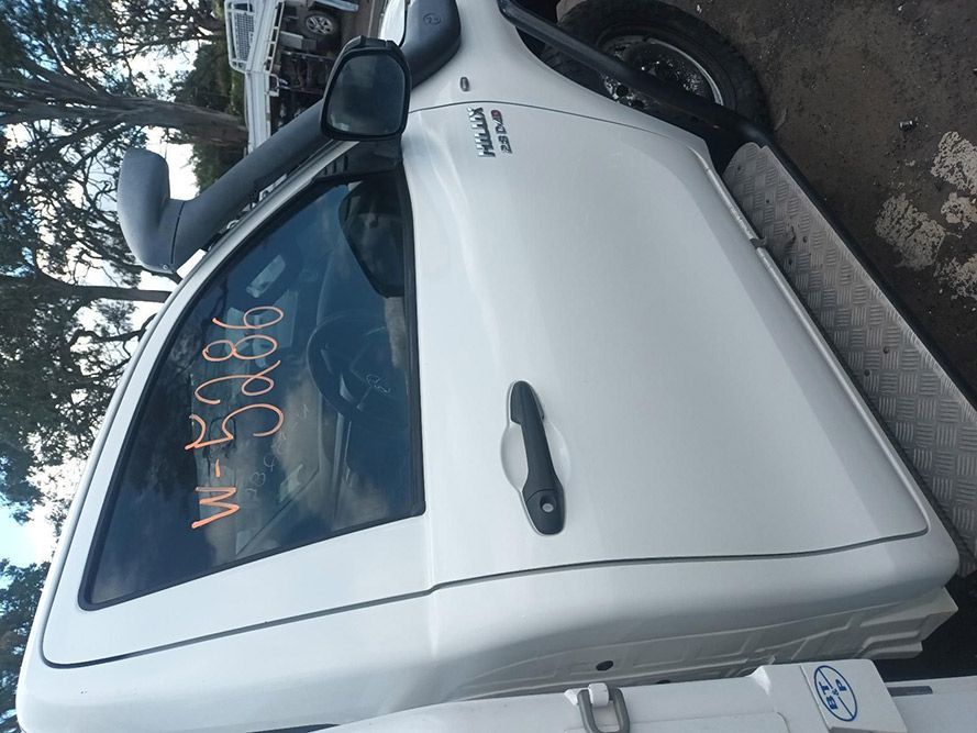 A White Truck is Parked on the Side of the Road — South West 4WD Wreckers In Brisbane, QLD
