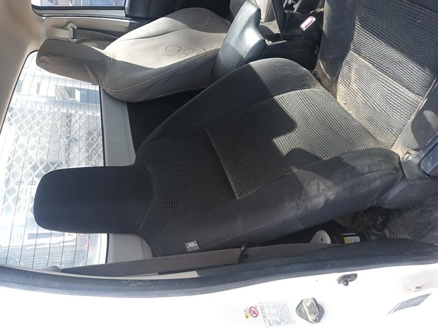 A White Car with Black Seats and a Steering Wheel — South West 4WD Wreckers In Brisbane, QLD