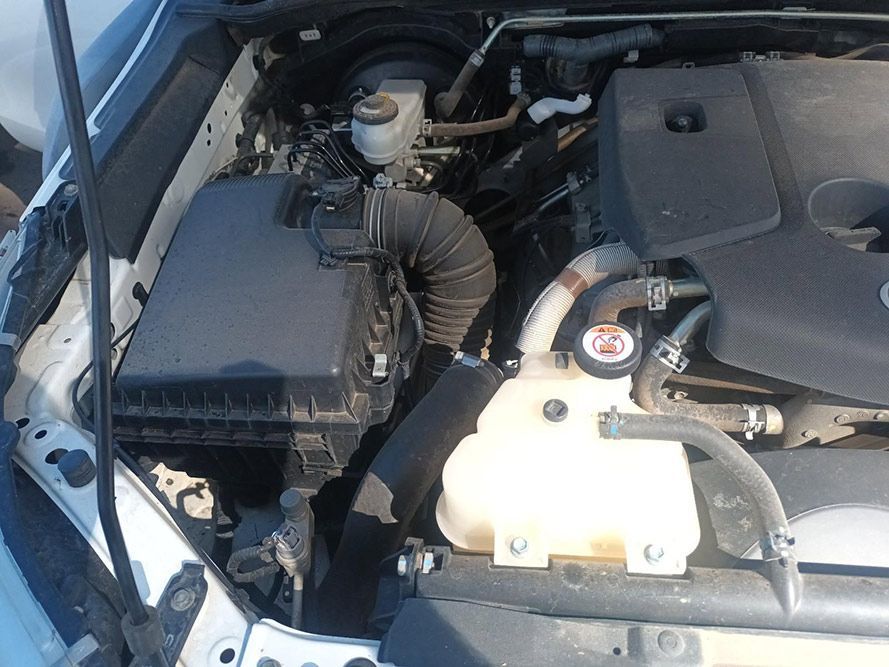 The Engine of a White Car is Shown with the Hood Open — South West 4WD Wreckers In Brisbane, QLD