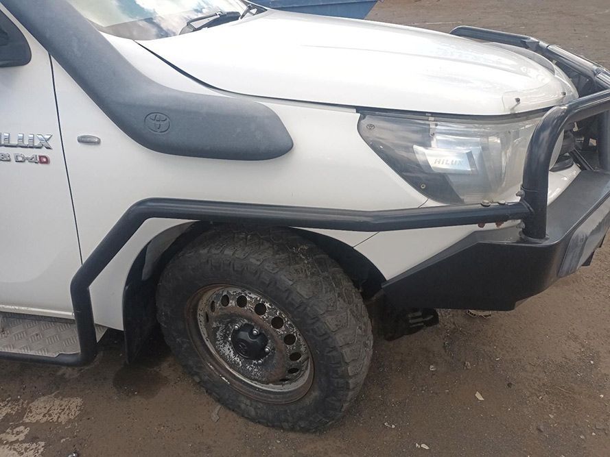 A White Truck with a Black Bumper is Parked on a Dirt Road — South West 4WD Wreckers In Brisbane, QLD
