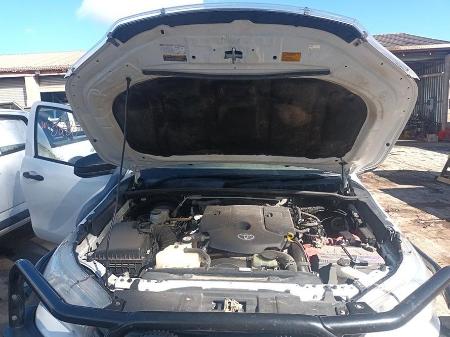 The Hood of a White Truck is Open and the Engine is Visible — South West 4WD Wreckers In Brisbane, QLD