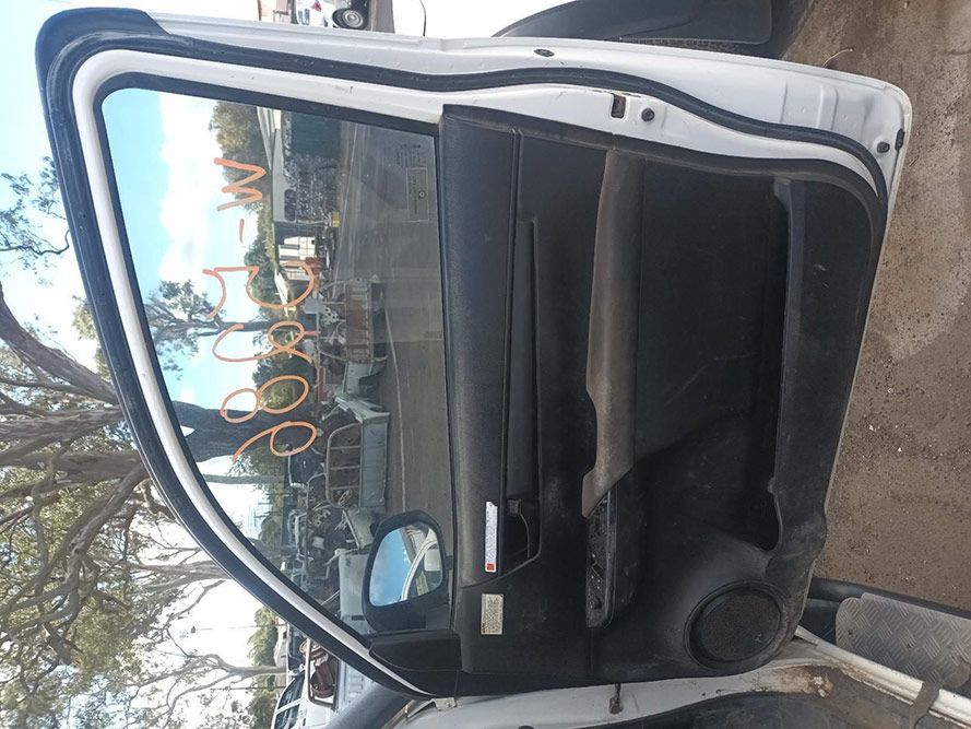 A White Car with the Door Open is Parked in a Parking Lot — South West 4WD Wreckers In Brisbane, QLD