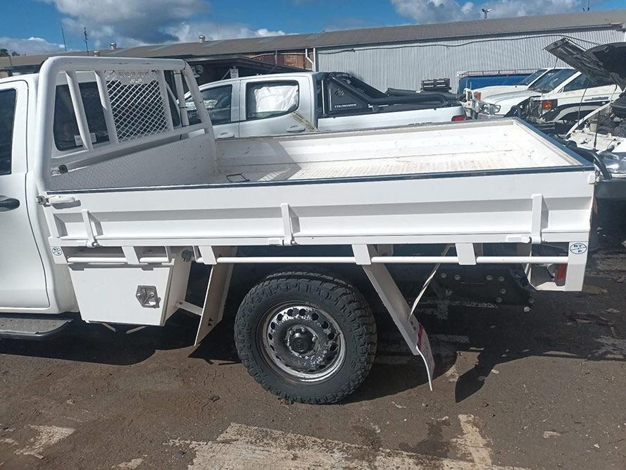 A White Truck with a Flat Bed is Parked in a Parking Lot — South West 4WD Wreckers In Brisbane, QLD