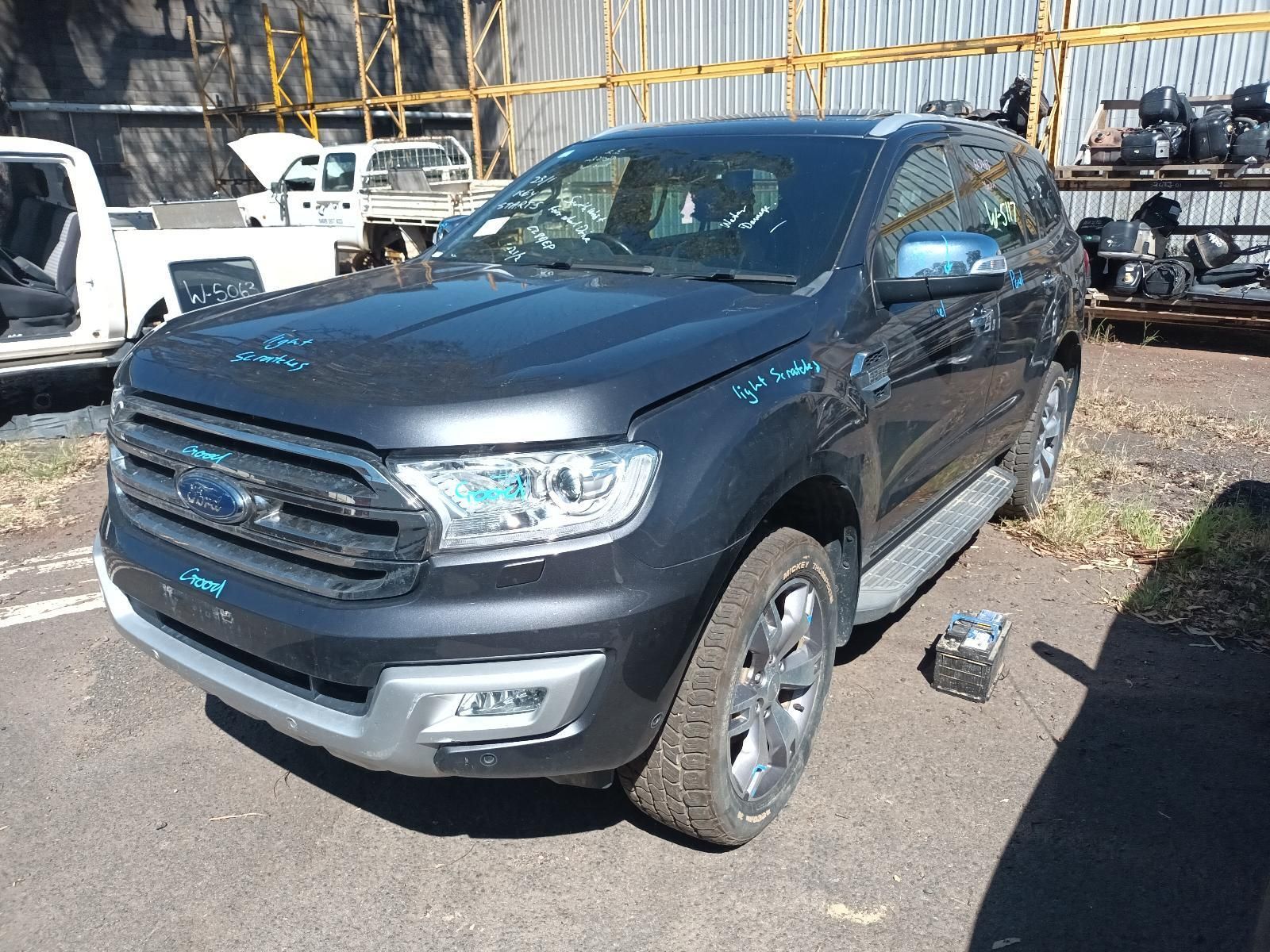 A White Truck With a Flat Tire is Parked on the Side of the Road — South West 4WD Wreckers In Brisbane, QLD