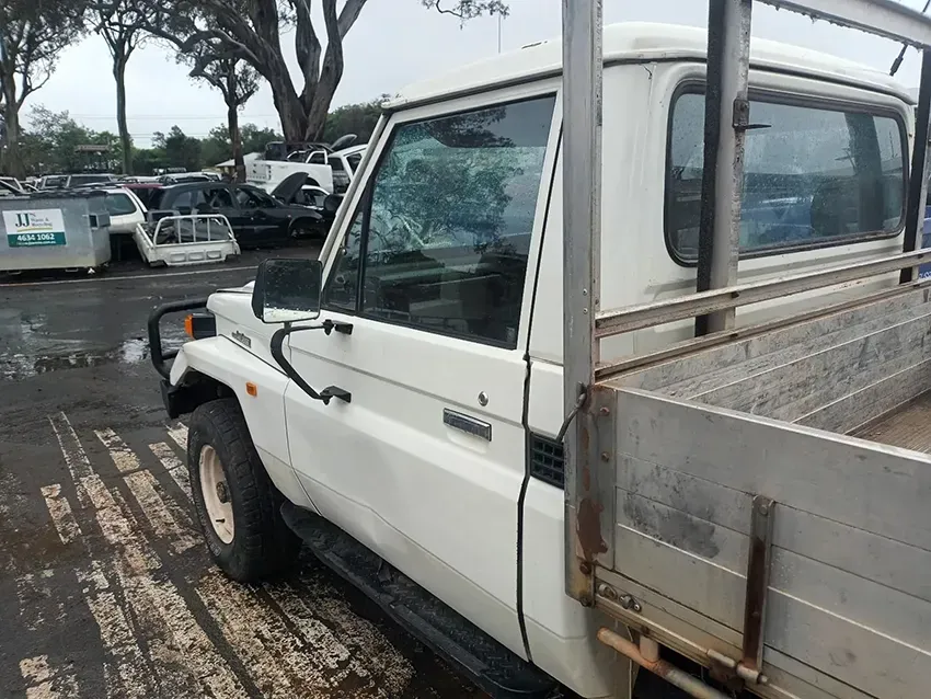A White Truck With a Broken Windshield is Parked in a Parking Lot — South West 4WD Wreckers In Brisbane, QLD