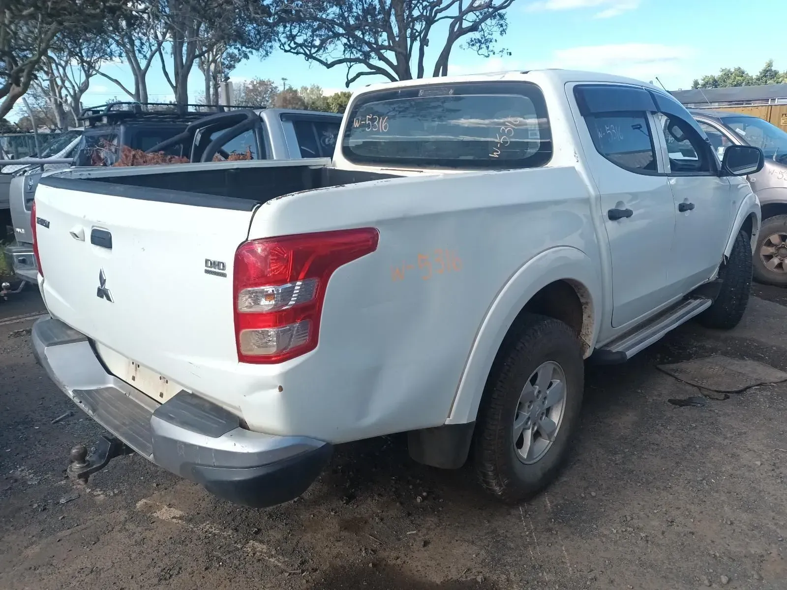 White Mitsubishi Pickup Truck, Parked Outdoors — South West 4WD Wreckers In Harristown, QLD