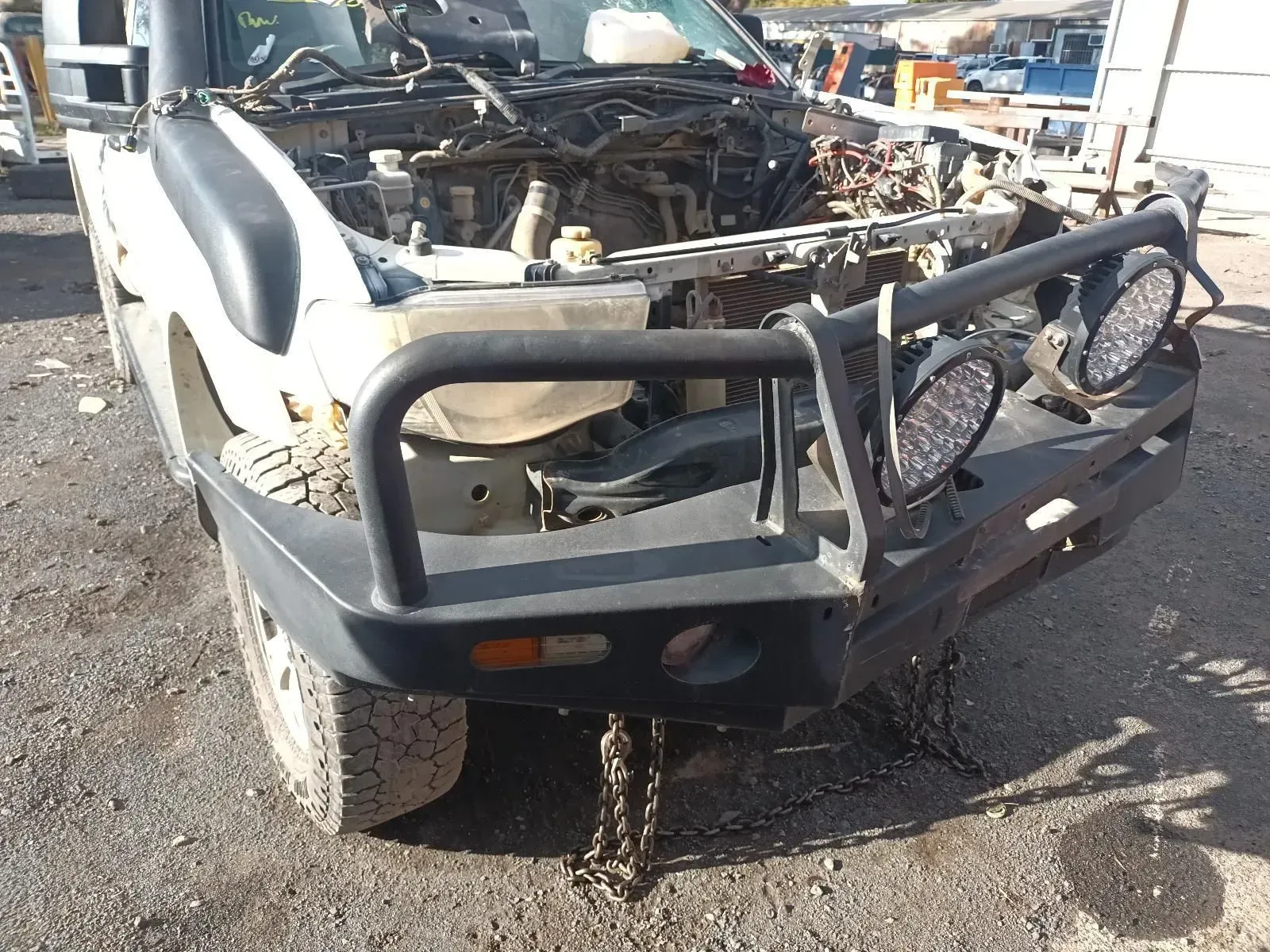 White Truck With Black Bull Bar, Missing Front Components, in a Junkyard — South West 4WD Wreckers In Brisbane, QLD