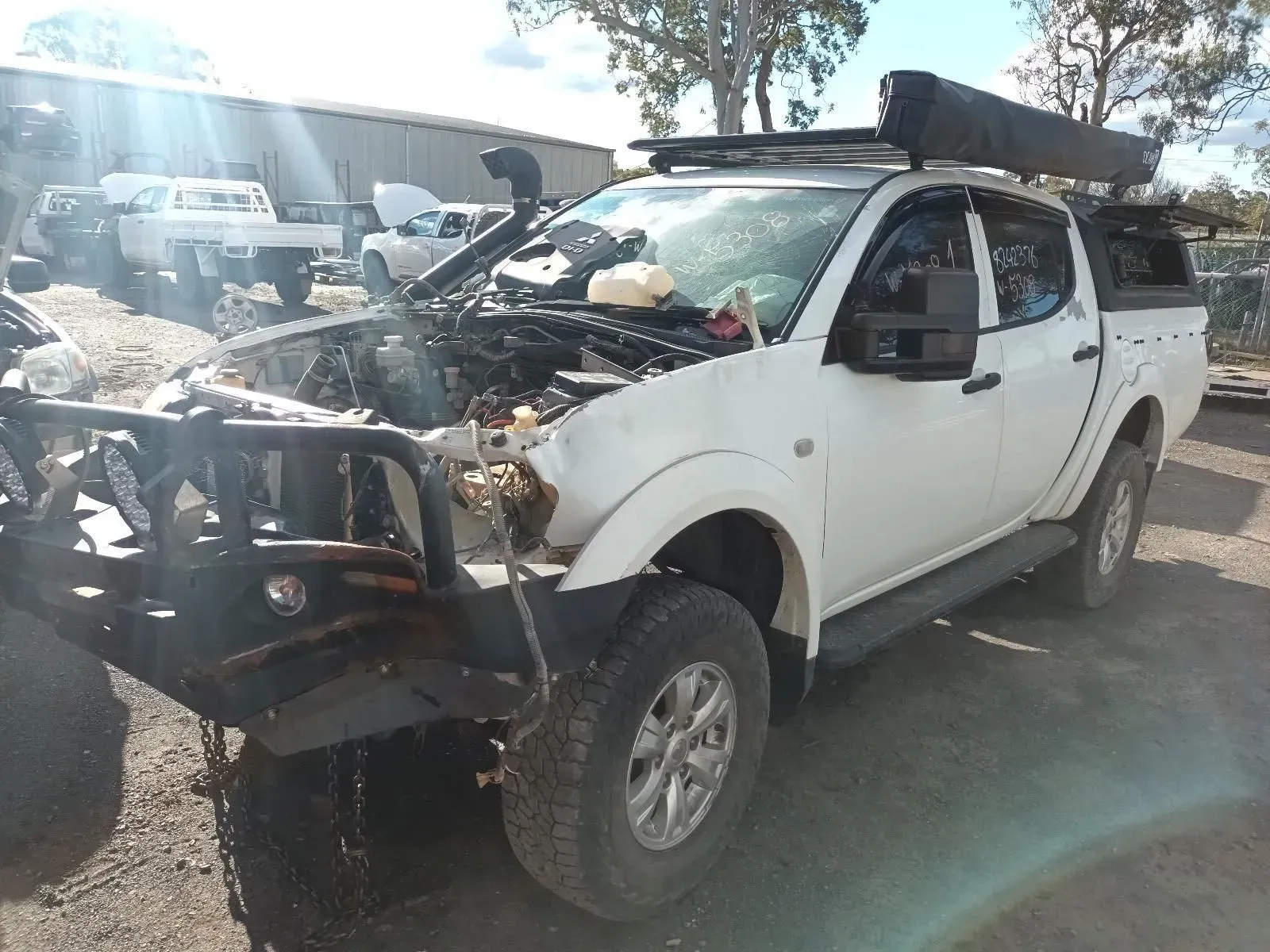 White, Damaged Pickup Truck at a Junkyard — South West 4WD Wreckers In Brisbane, QLD