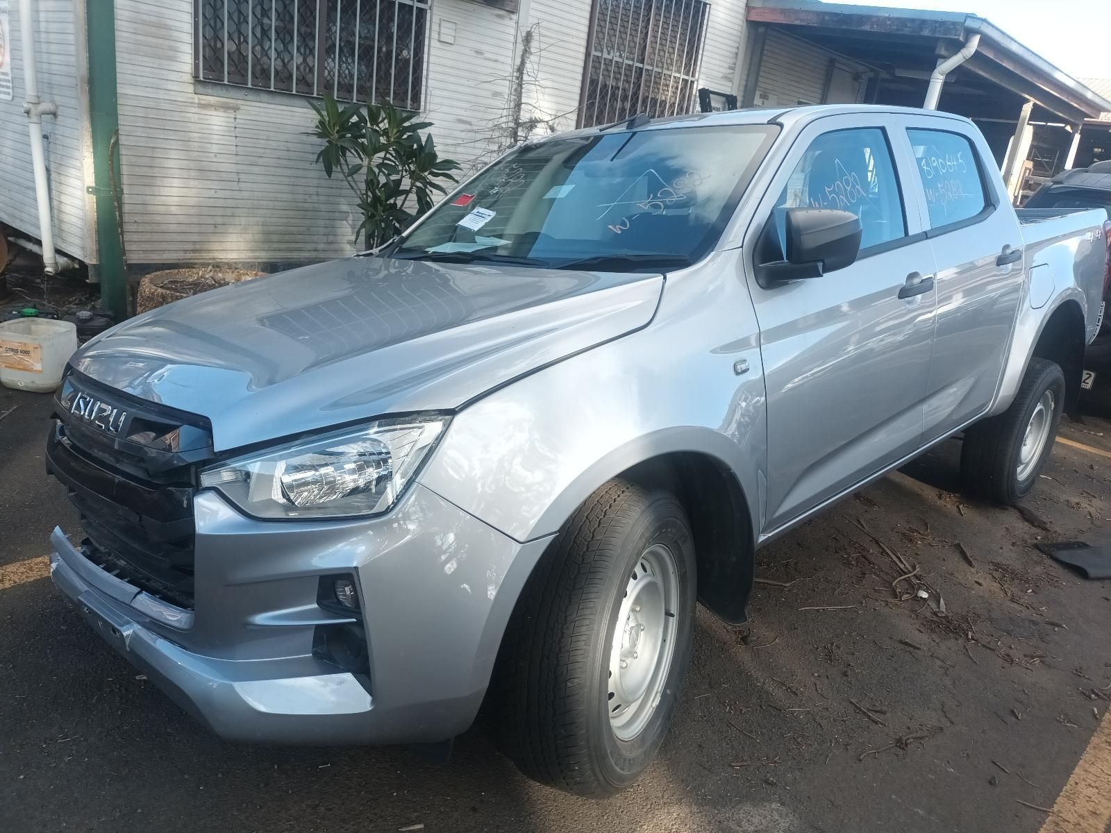 A Silver Pickup Truck is Parked in Front of a House — South West 4WD Wreckers In Brisbane, QLD