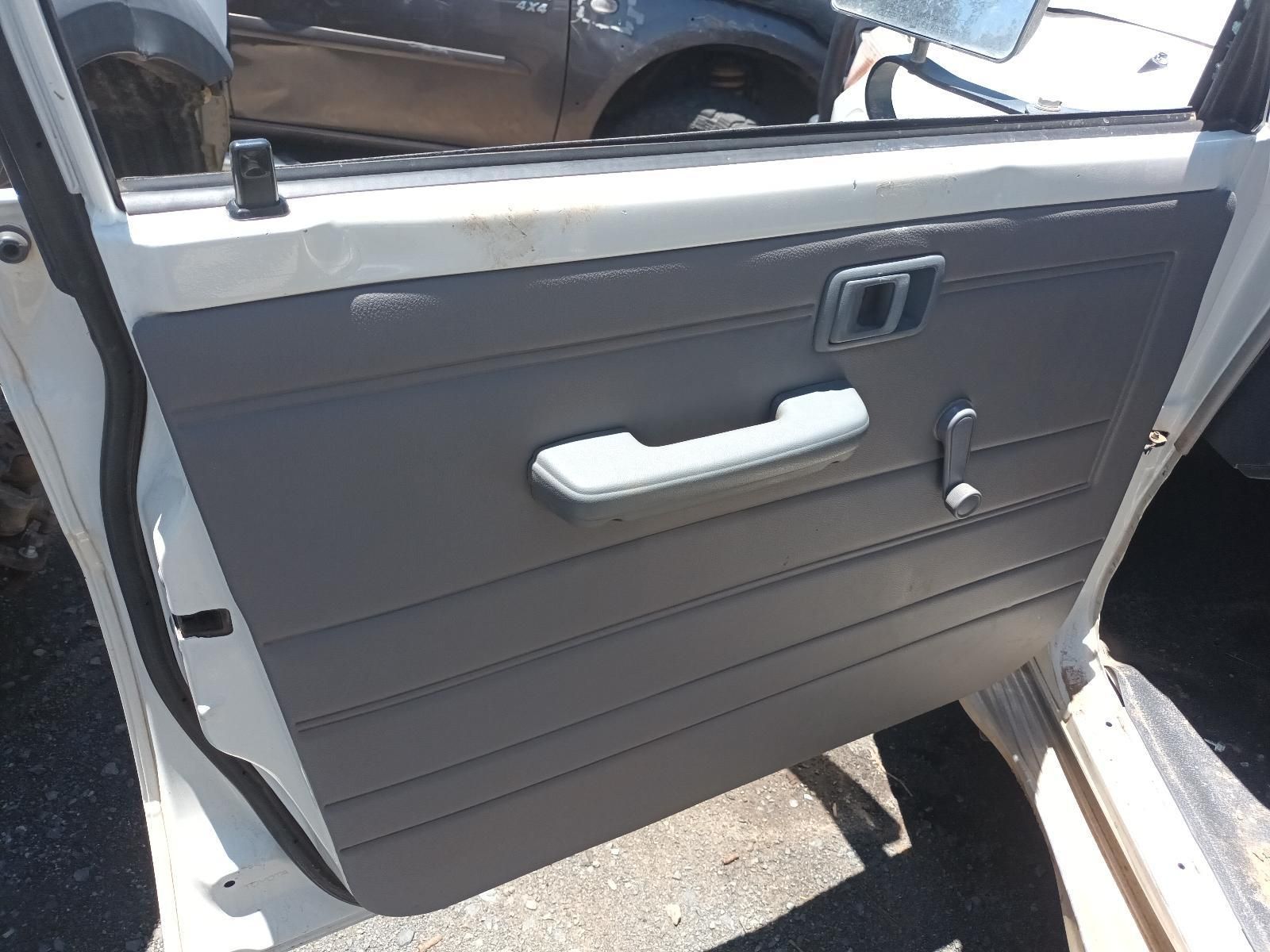 Open Car Door with Gray Interior Panel, White Handle, and Window Crank — South West 4WD Wreckers In Harristown, QLD