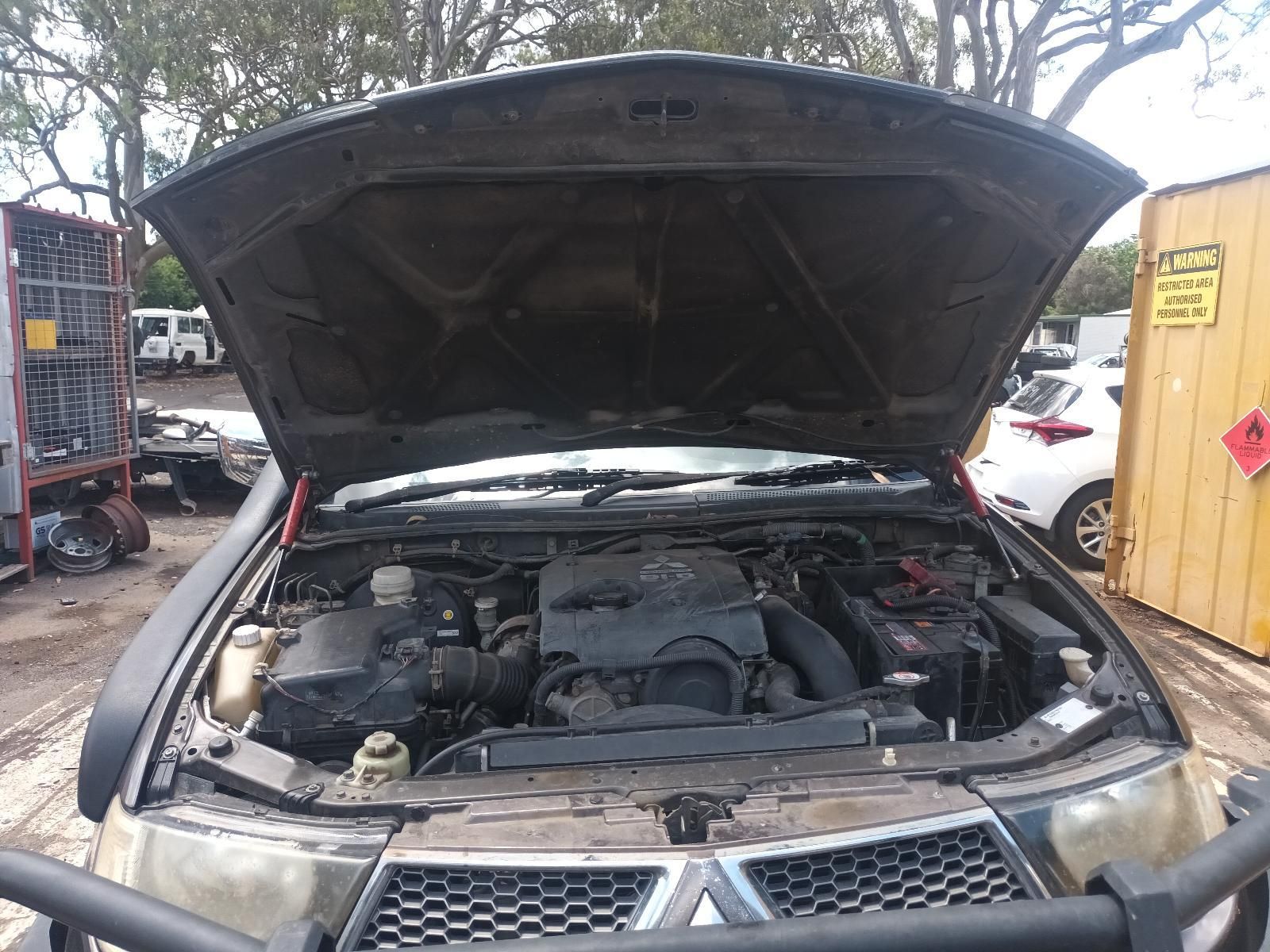 Open Car Hood Revealing Engine Bay in A Workshop — South West 4WD Wreckers In Harristown, QLD