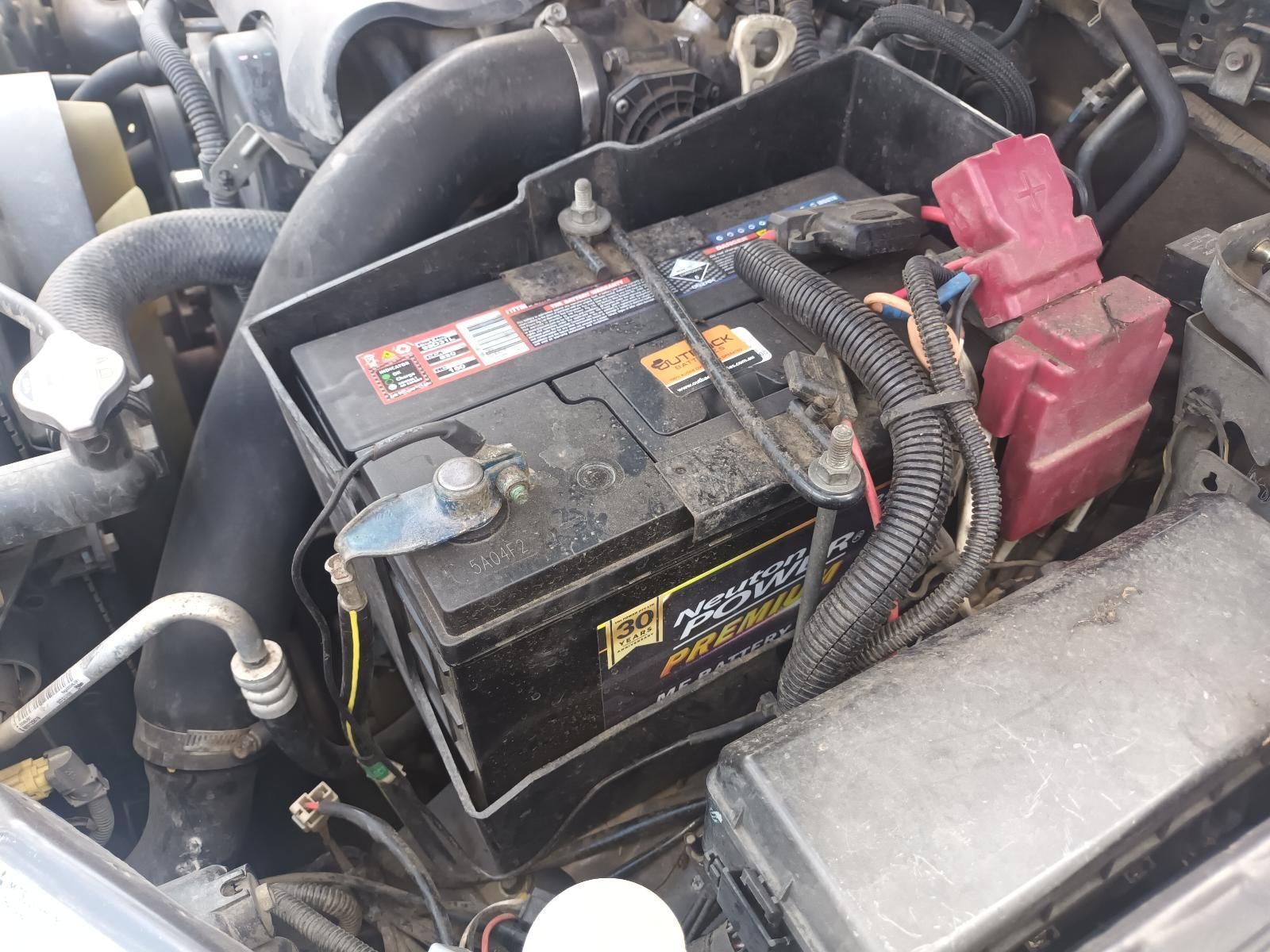 Car Battery in An Engine Bay, with Red Terminals — South West 4WD Wreckers In Harristown, QLD