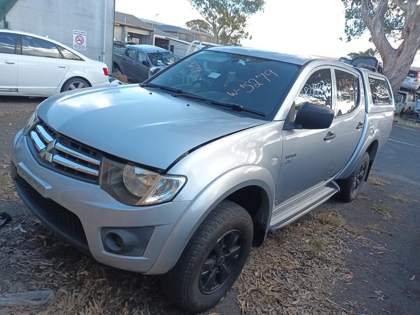 A White Truck With a Roof Rack is Parked in a Parking Lot — South West 4WD Wreckers In Brisbane, QLD
