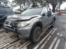 A White Truck is Parked in a Parking Lot in Front of a Building — South West 4WD Wreckers In Brisbane, QLD