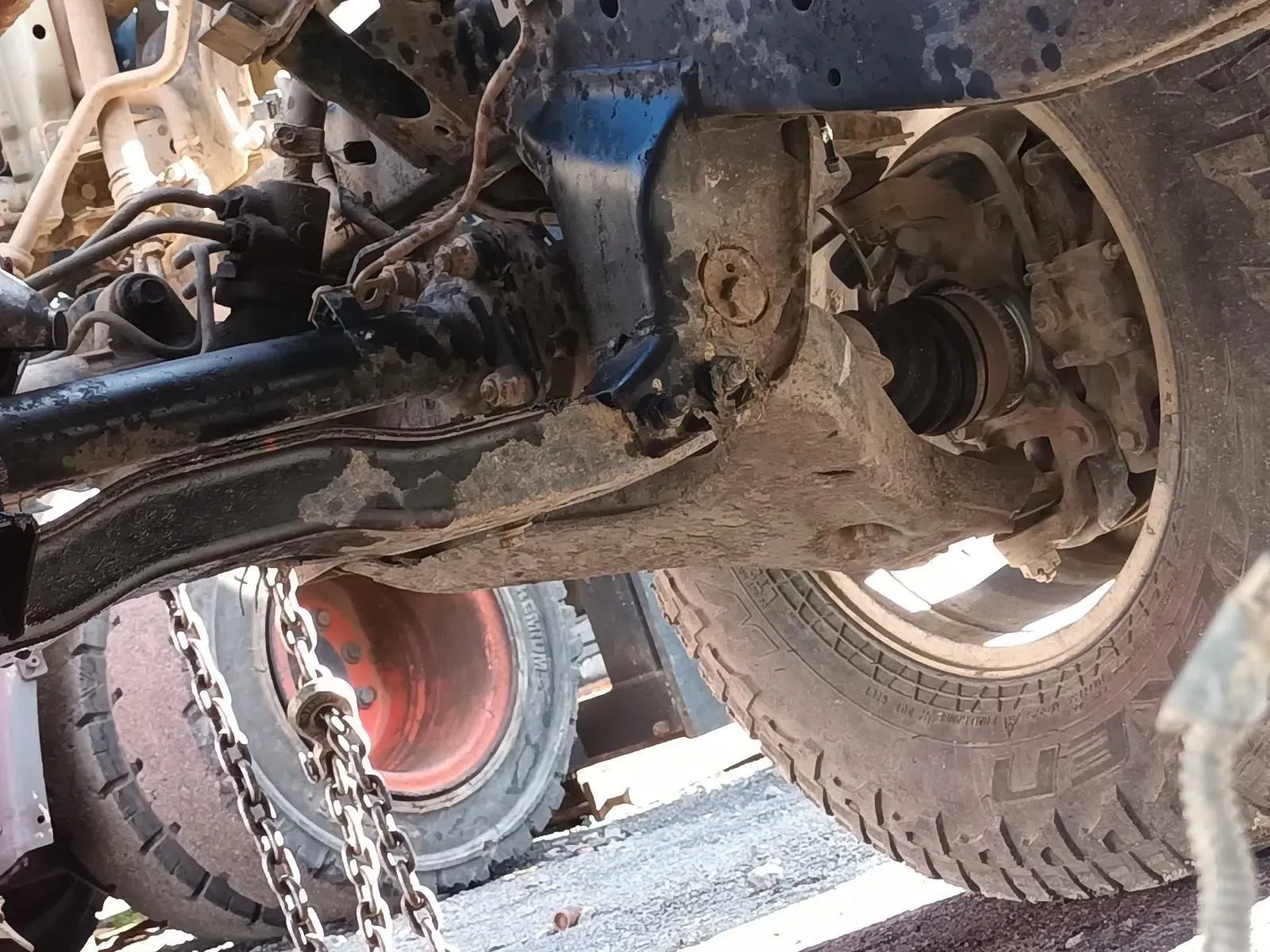 Front End Suspension of a Vehicle With a Tyre, Showing Damaged Components — South West 4WD Wreckers In Brisbane, QLD
