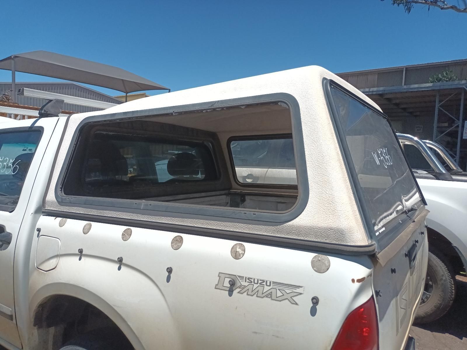 White Pickup Truck with A Camper Shell Parked Outdoors in A Lot — South West 4WD Wreckers In Harristown, QLD