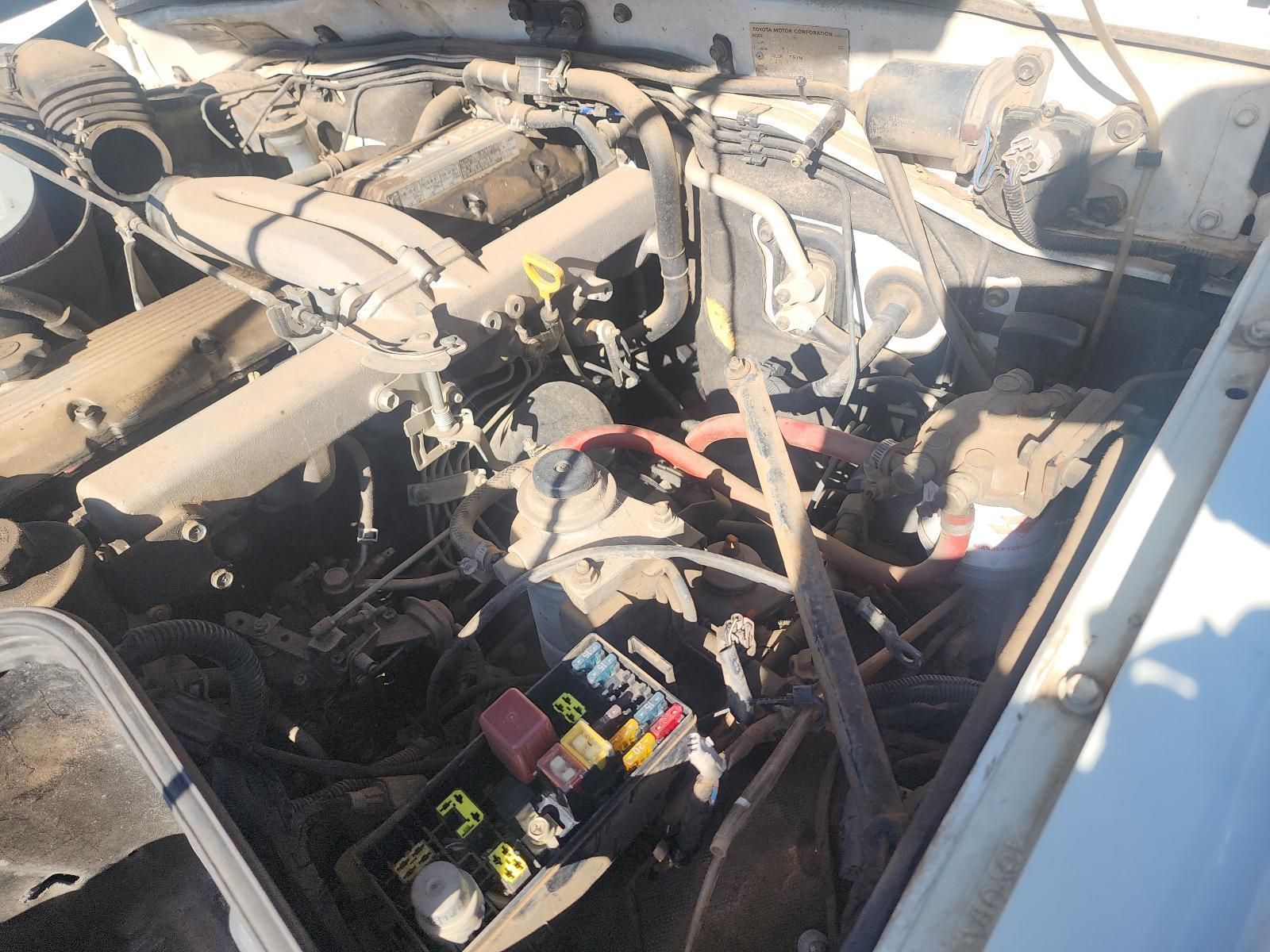 Car Engine Bay with Exposed Battery and Wiring Under the Hood — South West 4WD Wreckers In Harristown, QLD