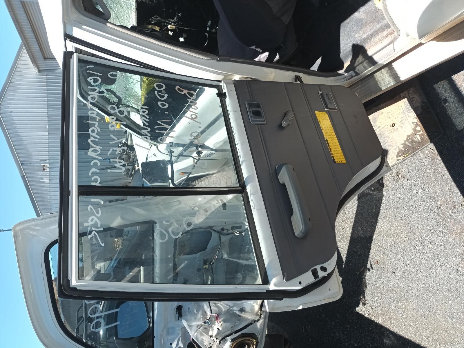 Damaged Bus Window and Door with Shattered Glass, Seen in Bright Daylight — South West 4WD Wreckers In Harristown, QLD