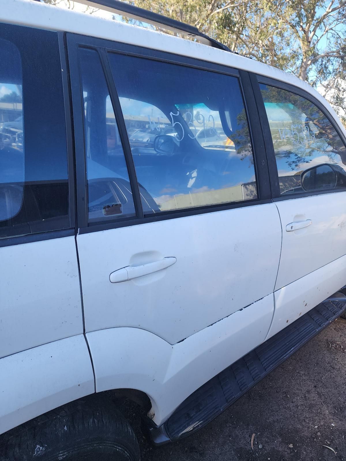 White Minivan Parked Outdoors in Sunlight — South West 4WD Wreckers In Harristown, QLD