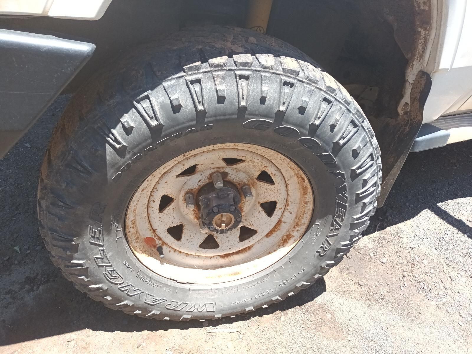 Close-Up of A Muddy Off-Road Tire on A Rusty Steel Rim on A Vehicle — South West 4WD Wreckers In Harristown, QLD