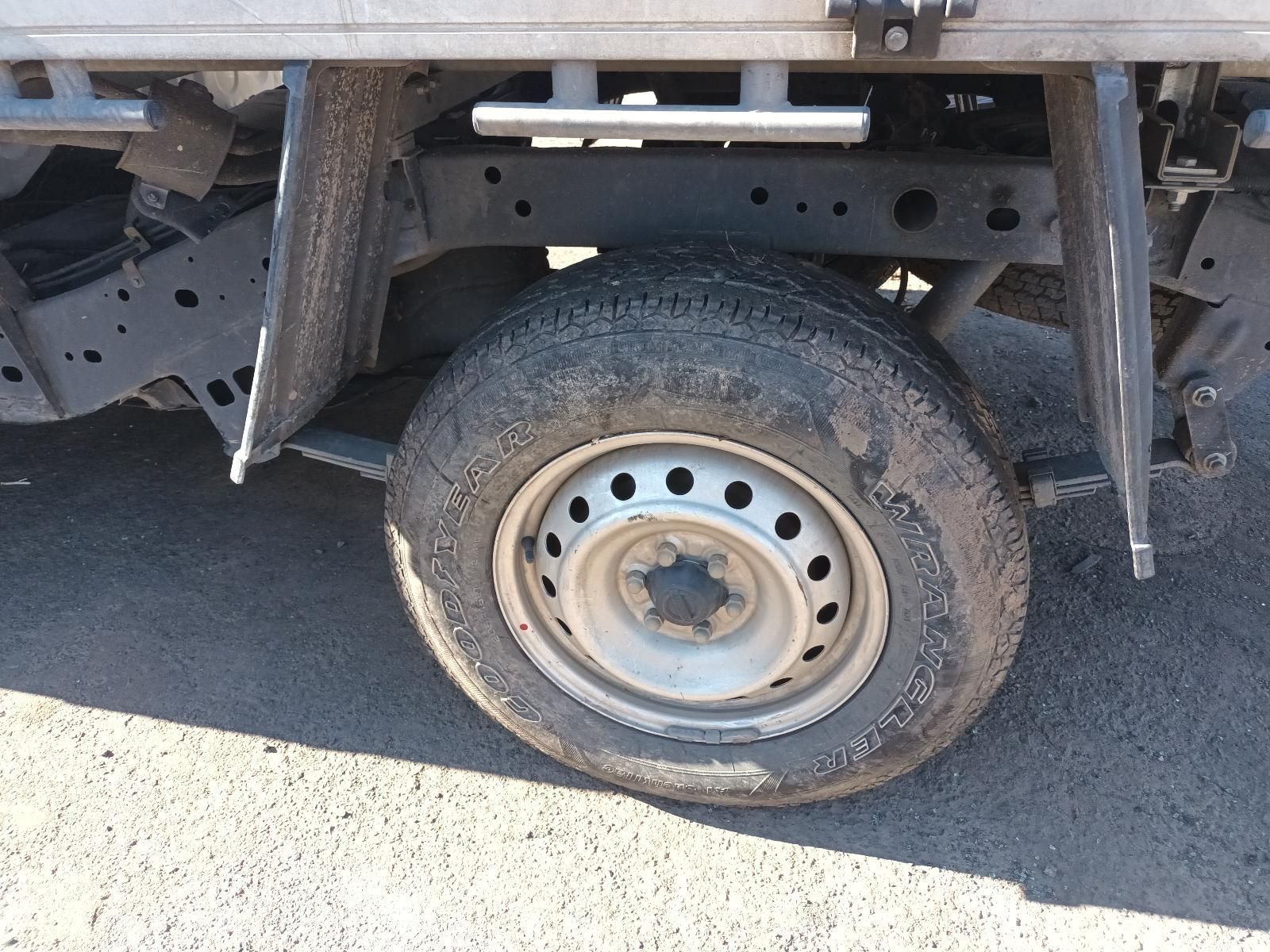 Close-up of a Dusty Truck Wheel With a Flat Tire on a Sunlit Road — South West 4WD Wreckers In Harristown, QLD