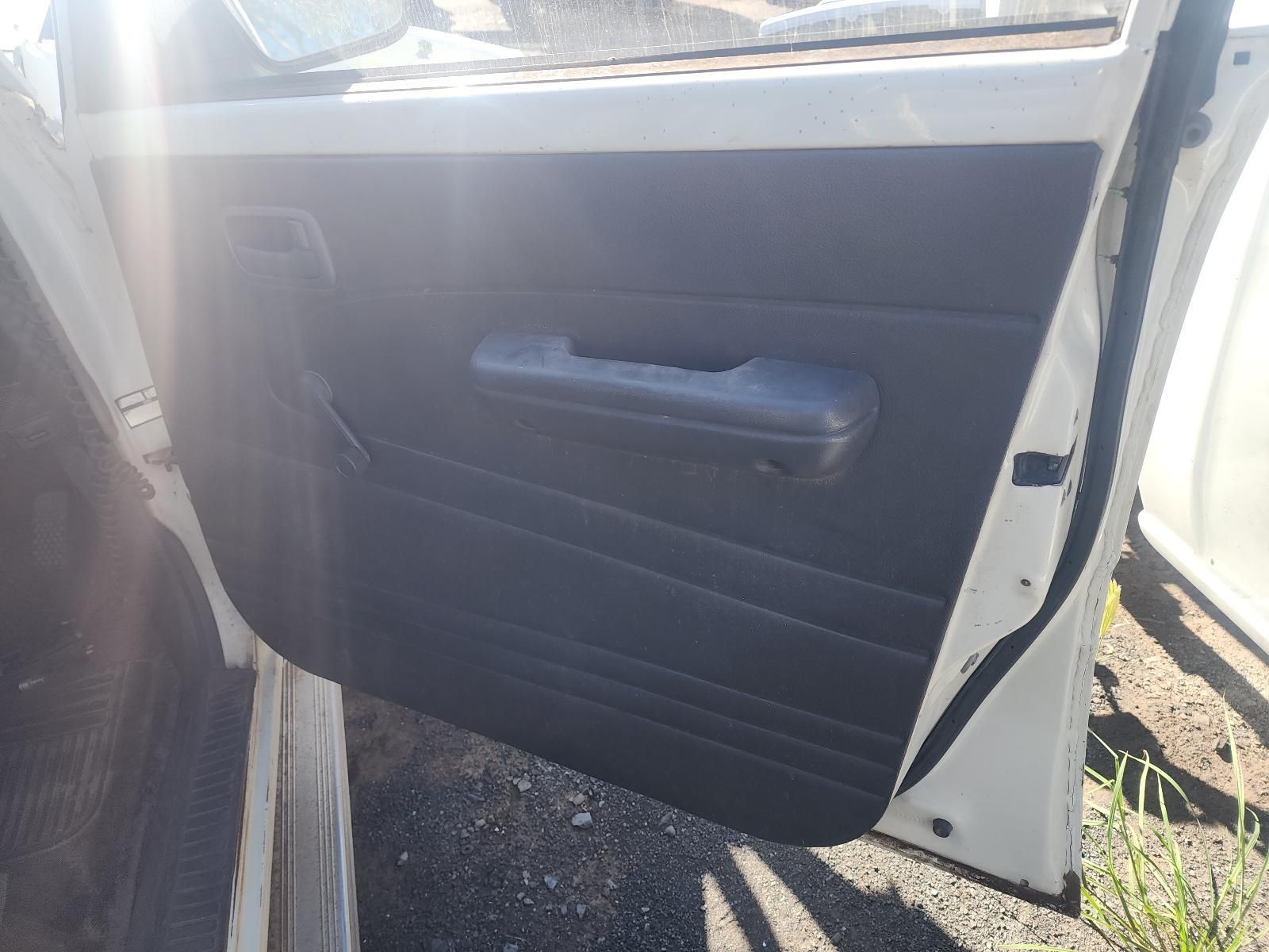 Open White Car Door with Black Interior Panel and Handle in Sunlight — South West 4WD Wreckers In Harristown, QLD