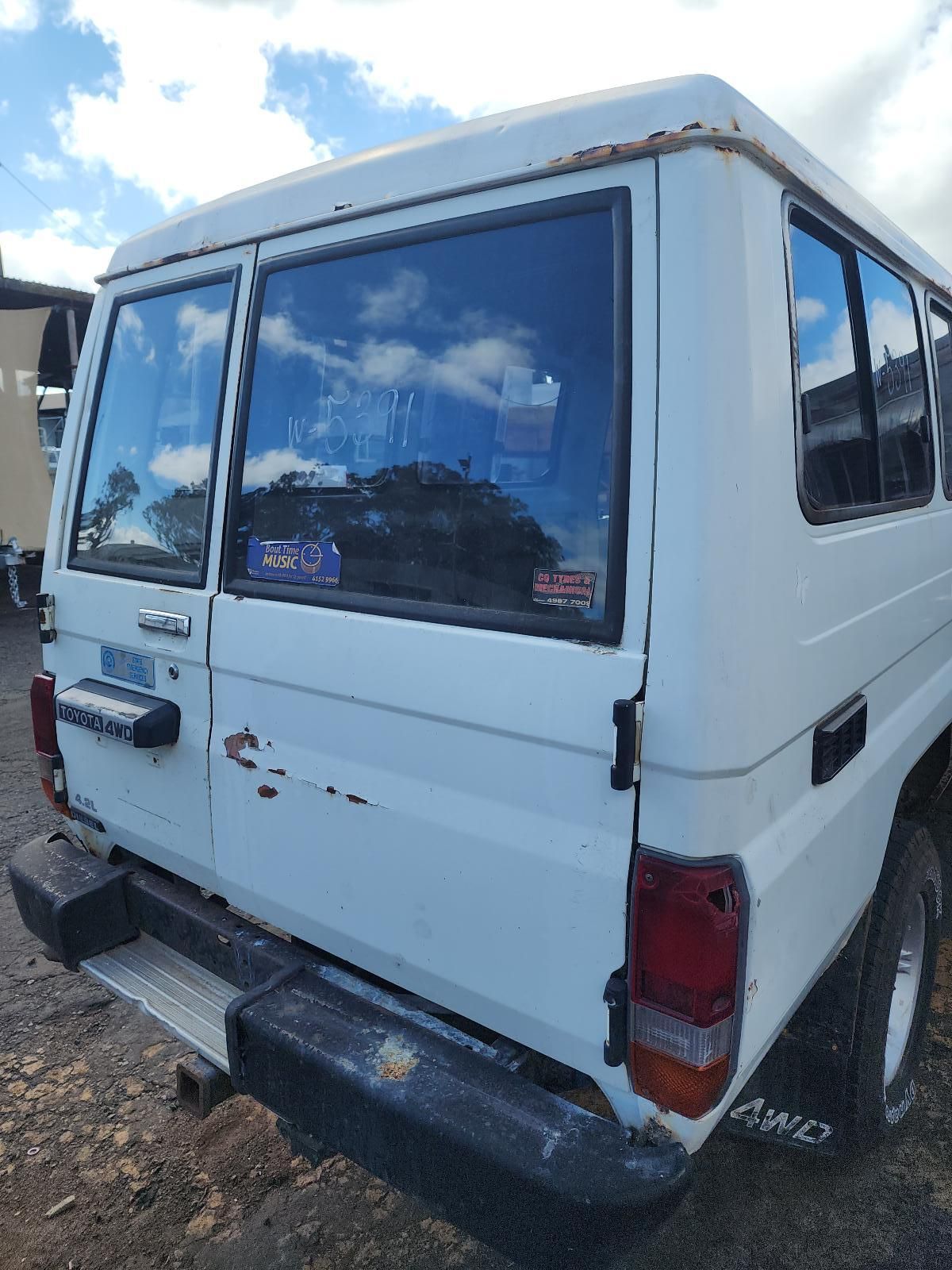 White Van Parked on a Dirt Lot — South West 4WD Wreckers In Harristown, QLD