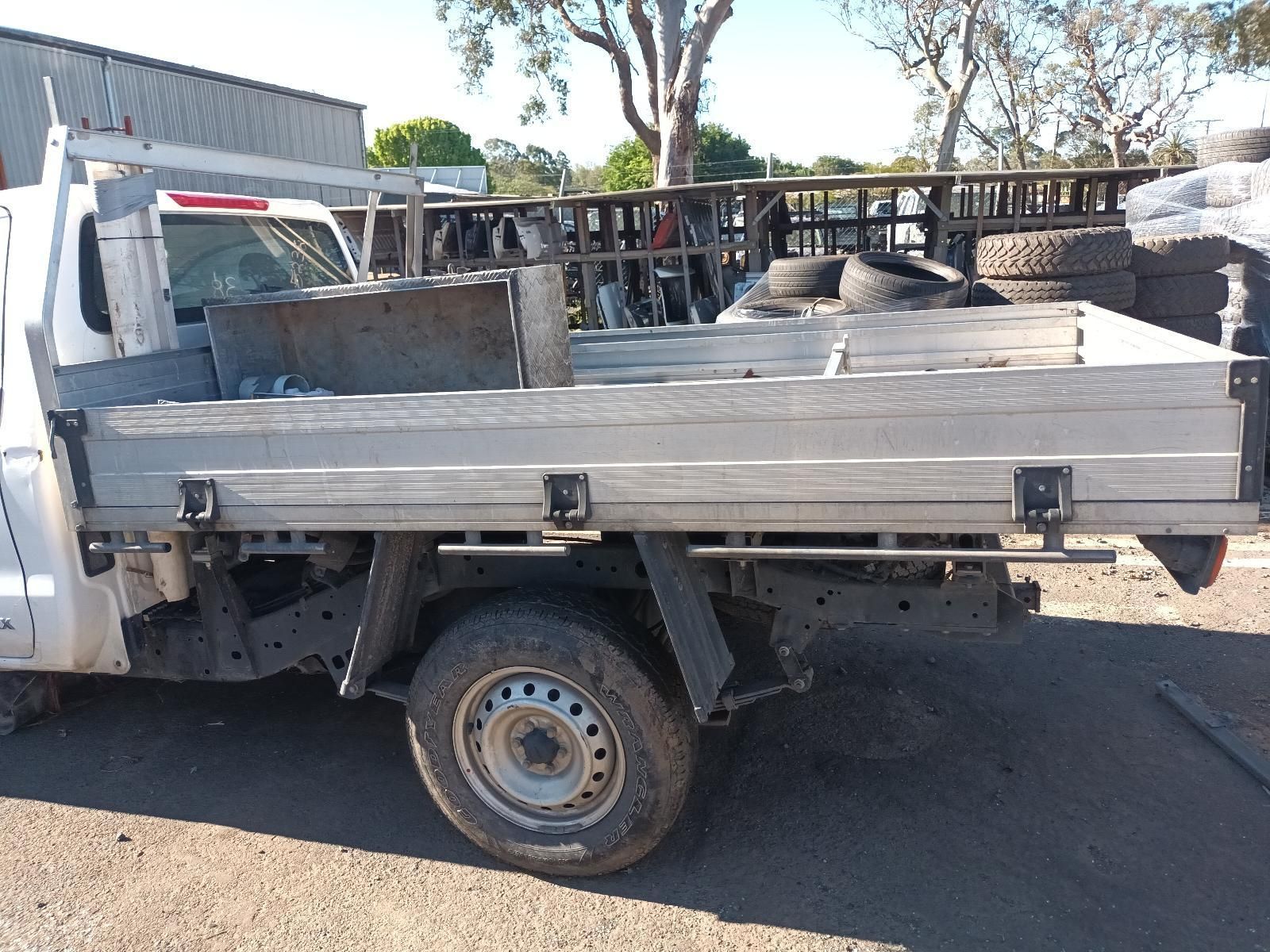White Flatbed Truck Loaded With Stacked Lumber — South West 4WD Wreckers In Harristown, QLD