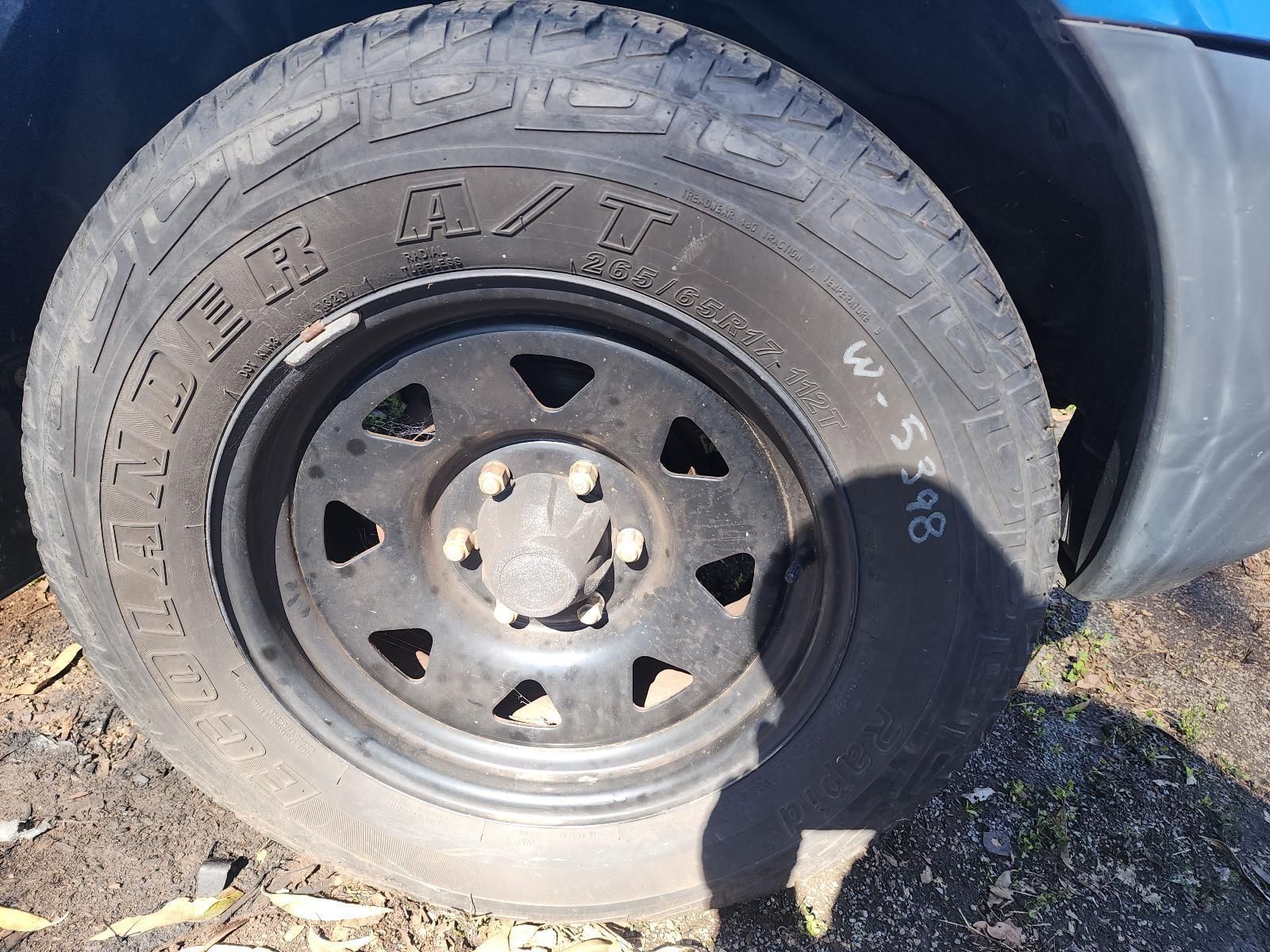 Black Steel Wheel With Worn Tire on a Vehicle — South West 4WD Wreckers In Harristown, QLD