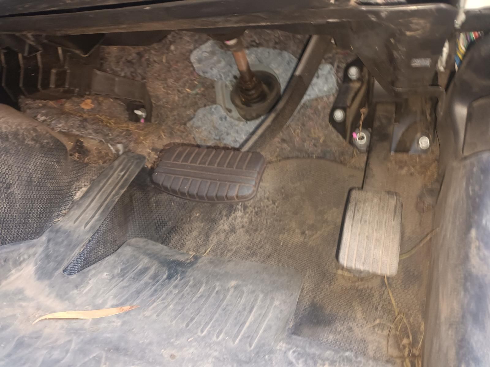 Dusty Vehicle Floor with Three Pedals and a Centre Console-Mounted Gear Shift — South West 4WD Wreckers In Harristown, QLD