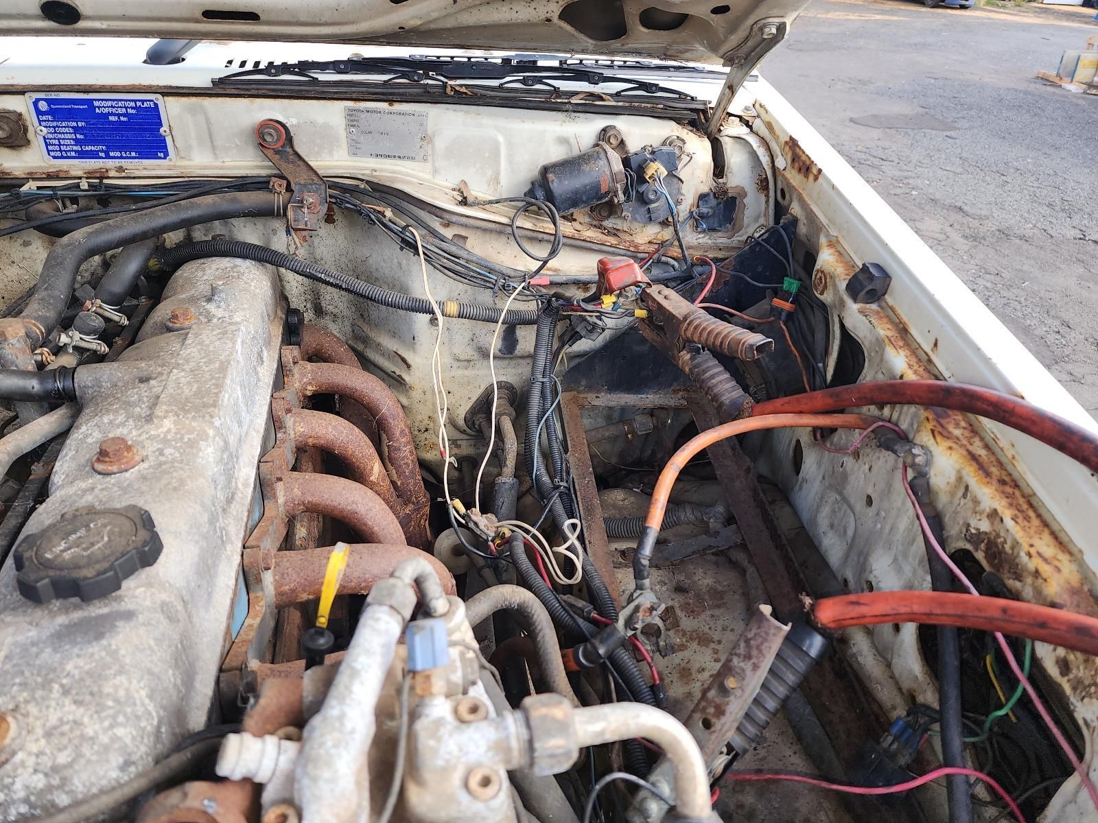 Open Car Hood Showing a Dusty Engine Bay — South West 4WD Wreckers In Harristown, QLD