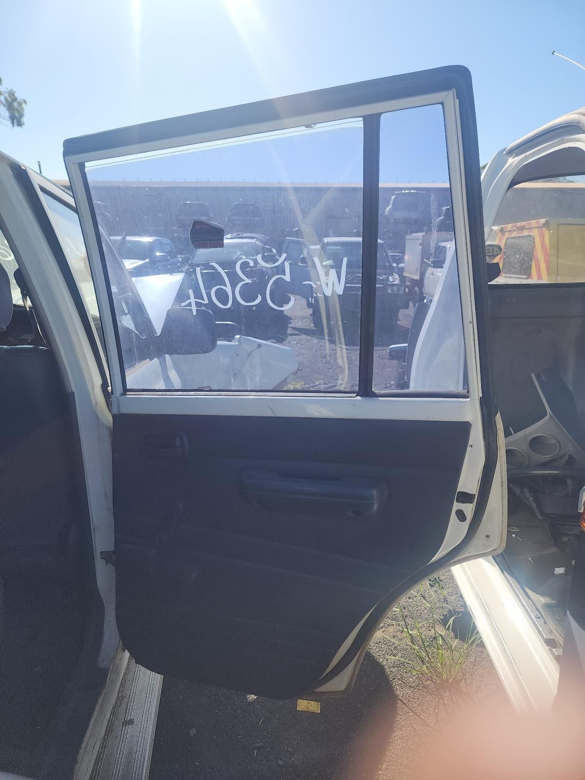 Open Car Door with Black Interior and Window Marked with White Writing — South West 4WD Wreckers In Harristown, QLD