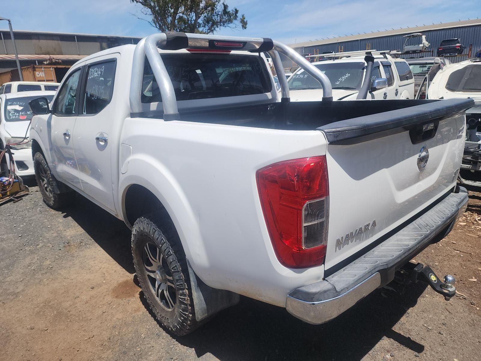 White Pickup Truck in a Dirt Lot, Rear Three-quarter View — South West 4WD Wreckers In Harristown, QLD