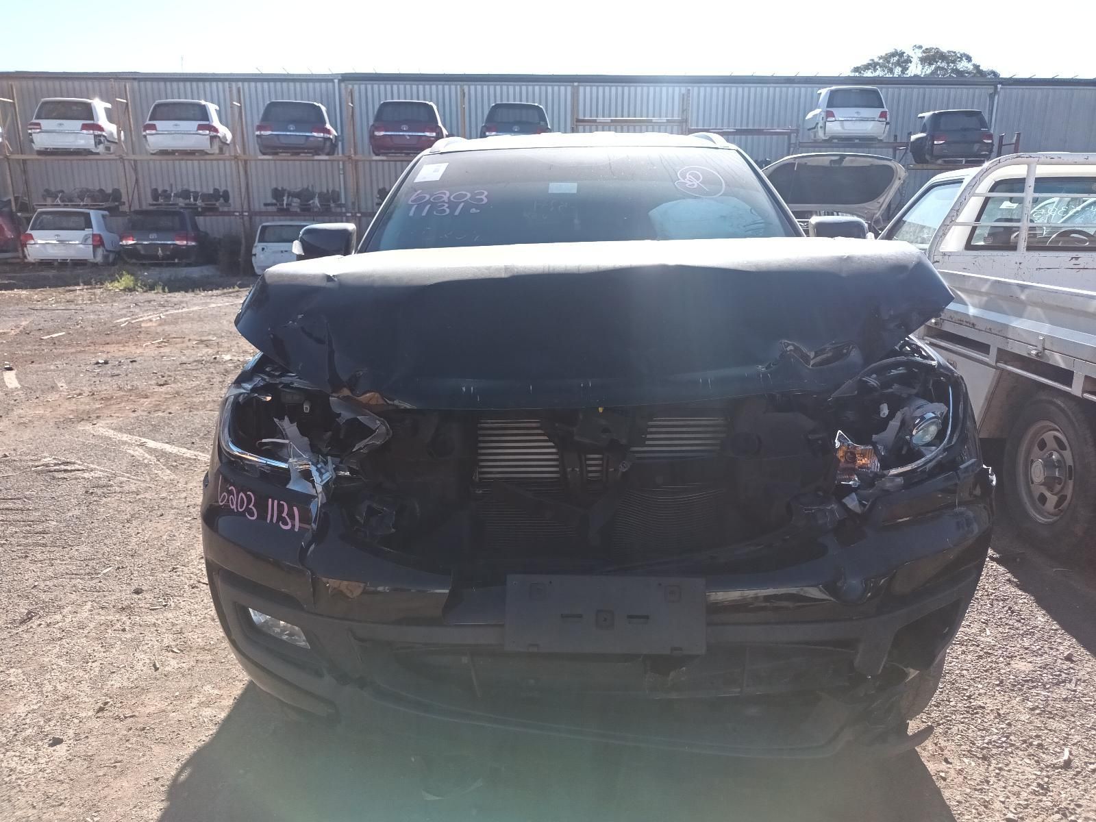 Front View of A Black Suv with Heavy Front-End Crash Damage in A Gravel Lot — South West 4WD Wreckers In Harristown, QLD