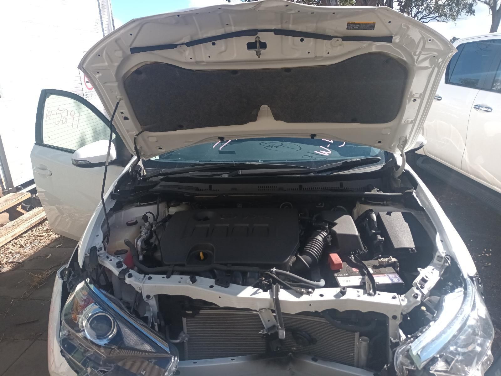The Hood of a White Car is Open and the Engine is Visible — South West 4WD Wreckers In Brisbane, QLD