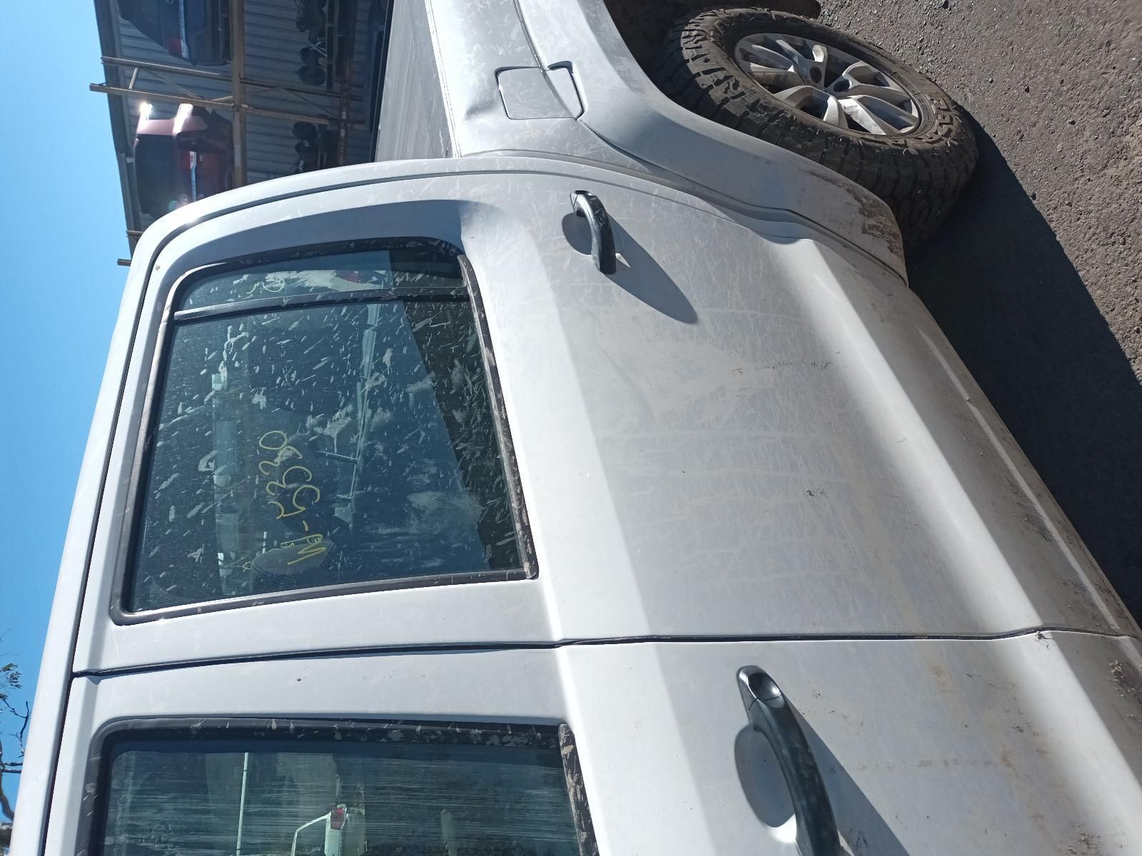 White Pickup Truck Parked on A Street, Side View with Rear Wheel Visible — South West 4WD Wreckers In Harristown, QLD