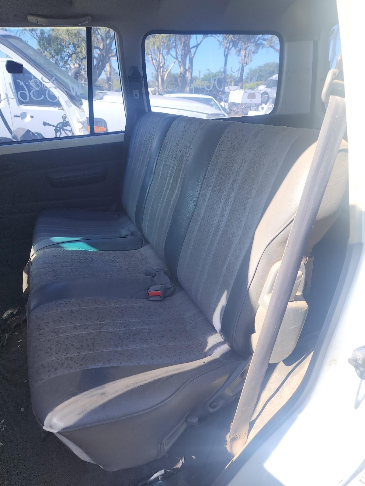 Truck Interior with a Grey Bench Seat and Seatbelts — South West 4WD Wreckers In Harristown, QLD