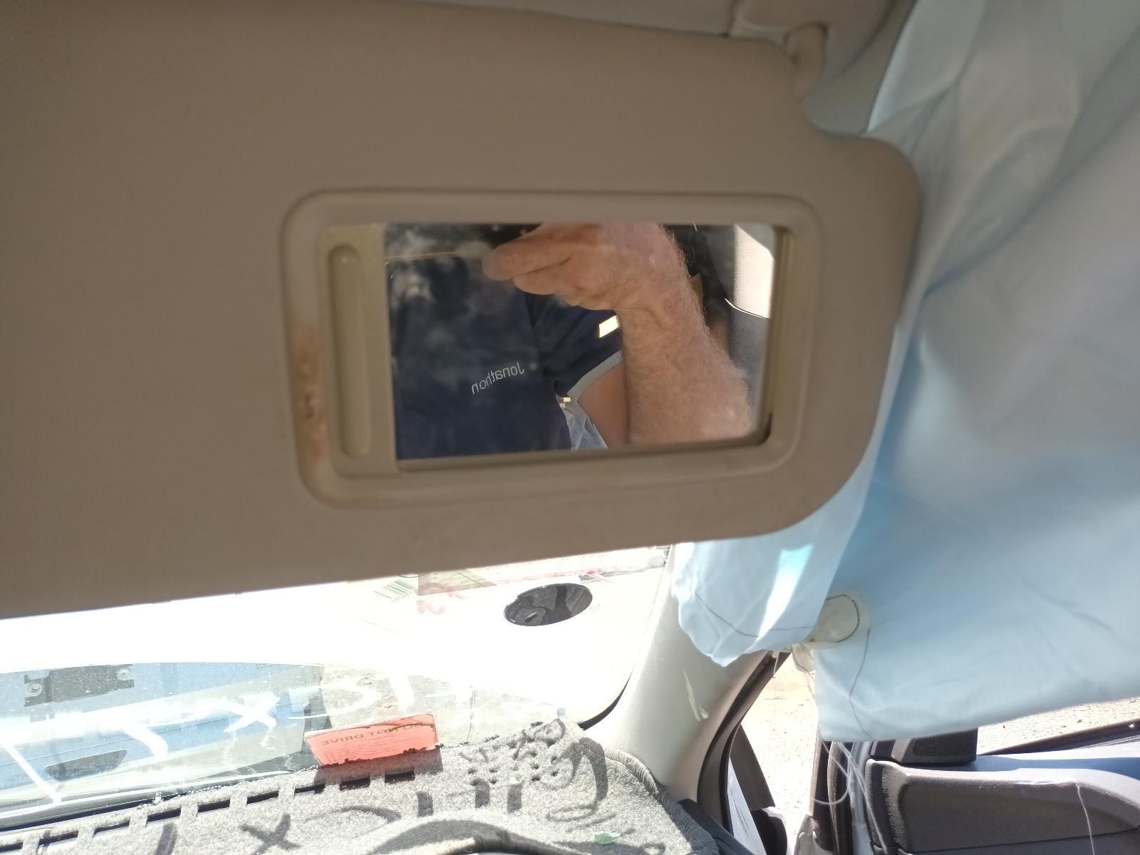 Car Interior with A Sun Visor Mirror Reflecting a Person — South West 4WD Wreckers In Harristown, QLD