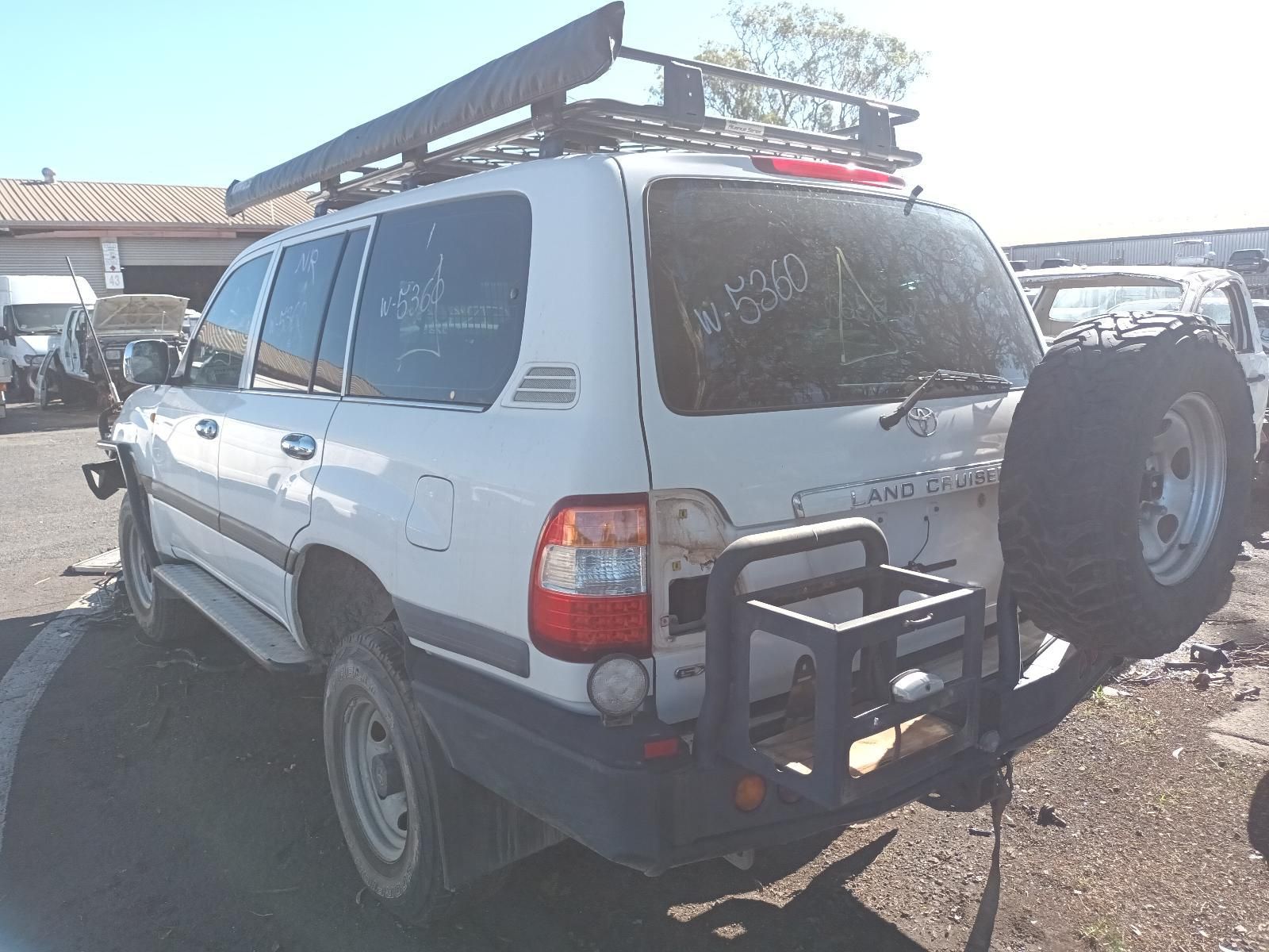 White Suv with Roof Rack and Rear-Mounted Spare Tyre Parked — South West 4WD Wreckers In Harristown, QLD