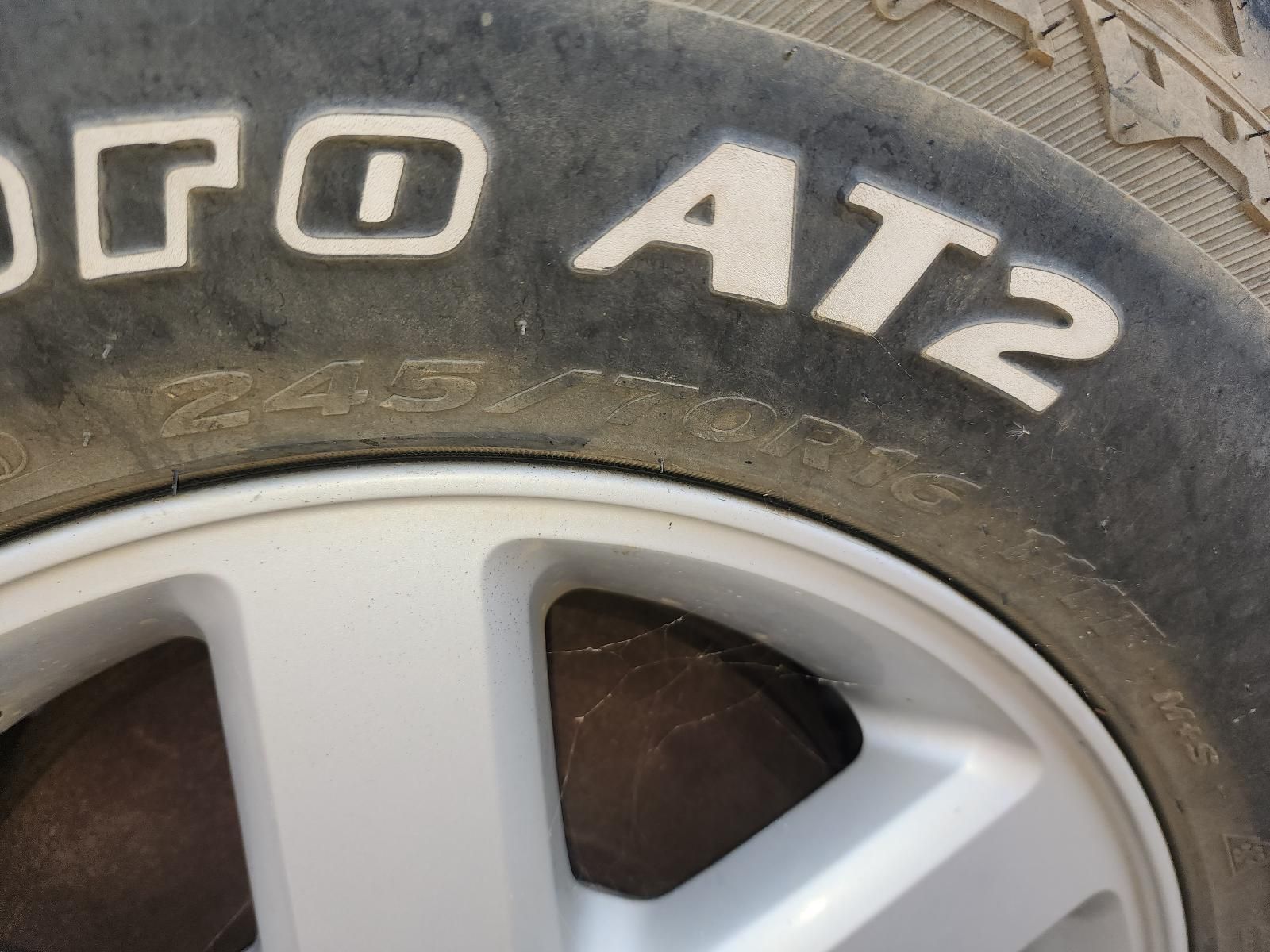 Close-up of a Dusty Car Tire and Silver Wheel Rim — South West 4WD Wreckers In Harristown, QLD