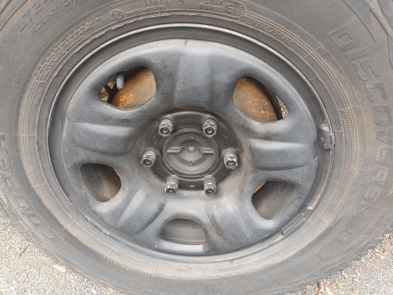 Close-Up of A Dusty Car Wheel with A Black Steel Rim — South West 4WD Wreckers In Harristown, QLD