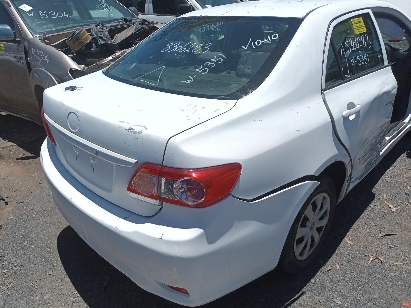Damaged White Sedan with Rear-End and Side Damage in A Parking Lot — South West 4WD Wreckers In Harristown, QLD